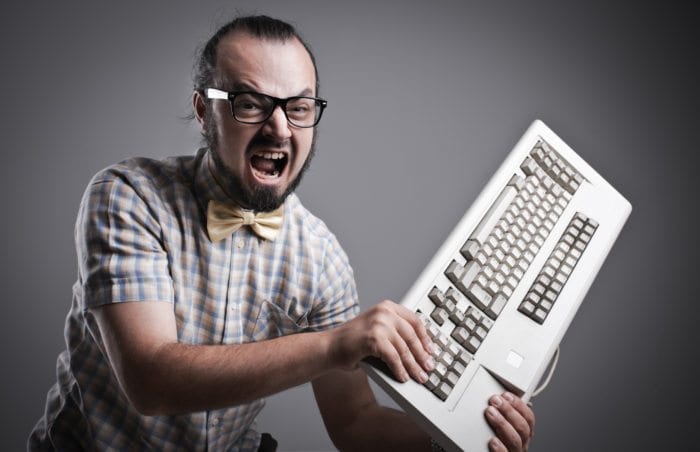 A man is about to destroy his keyboard