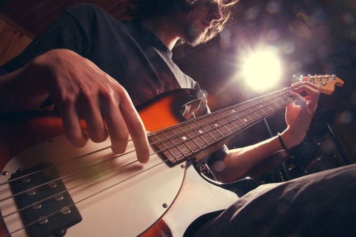 A man plays guitar.