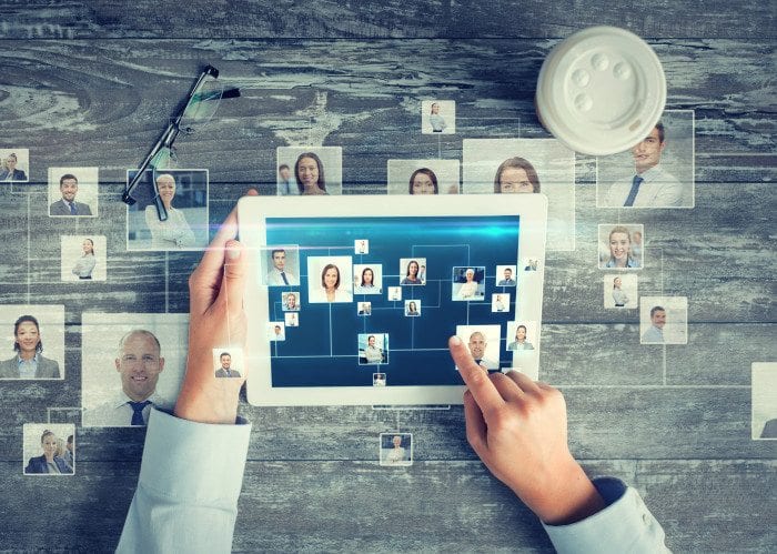6 Principles Of A Modern Optometry Website Design 1 A Man Is Using A Tablet with image of people emotionally connecting in them.