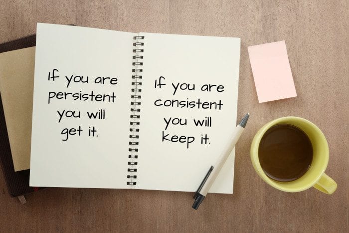 persistent and consistent written on a notebook