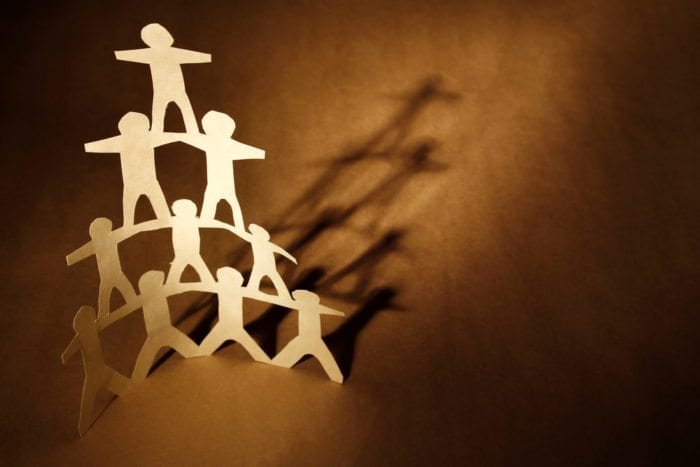 human shaped cut out stacked like a pyramid.