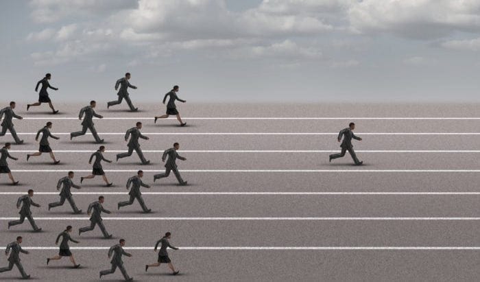 A black figure staying ahead of other black figure on a track