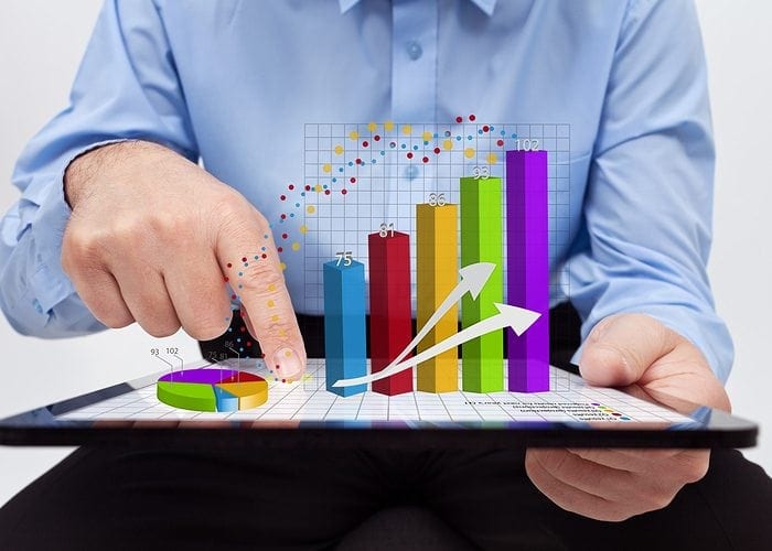 Hand working with a graph that is going up, to show increasing online marketing
