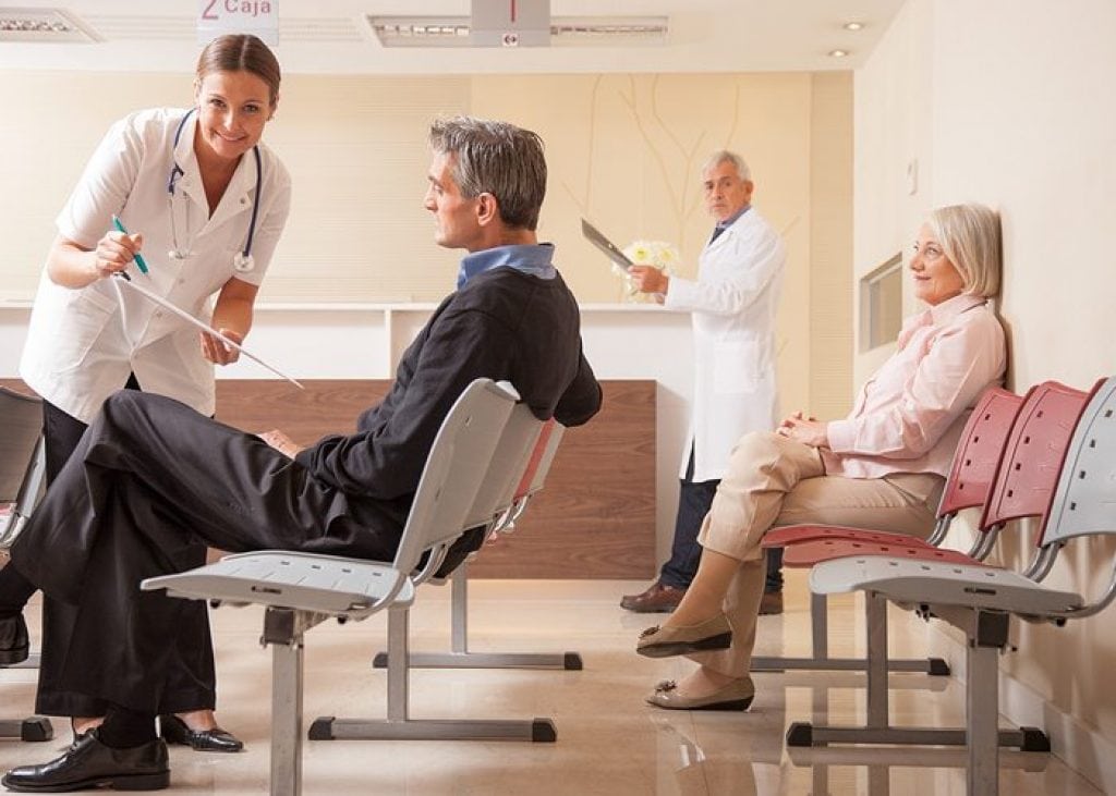 Boosting Patient Satisfaction 2 Patients In The Waiting Room At A Doctors Office.