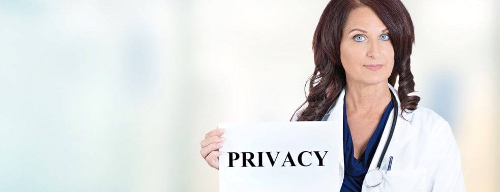 a female doctor holding the sign that says privacy