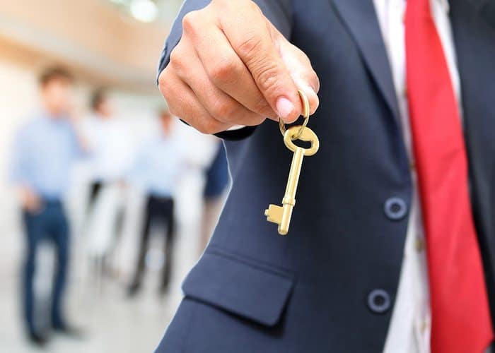 Man handing over the golden key