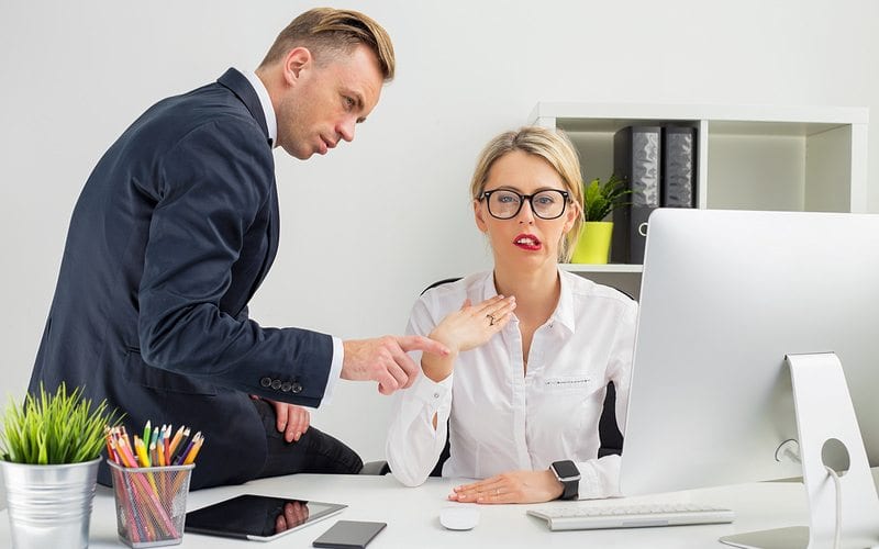 Man touching women's arm uncomfortably