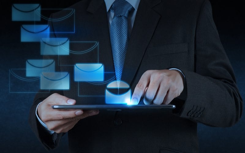 Guy typing email on tablet