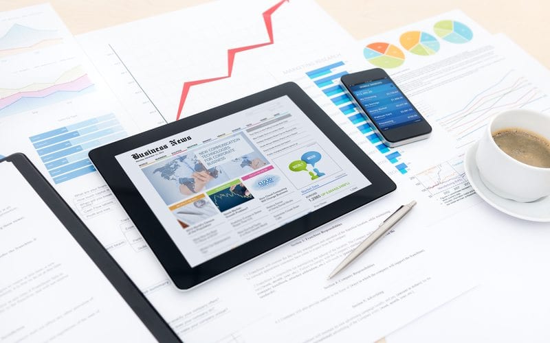 How To Audit Your Marketing Strategy 2 Marketing Metrics Displayed On Devices And Paper