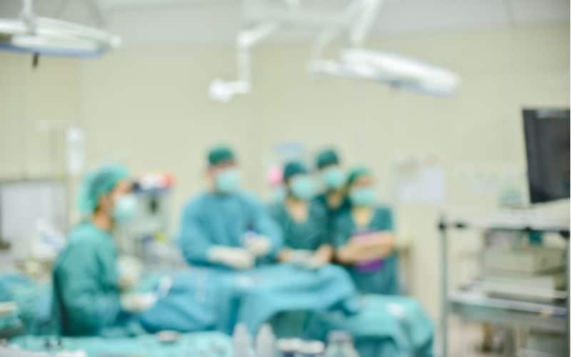 plastic surgeon and team working blurred