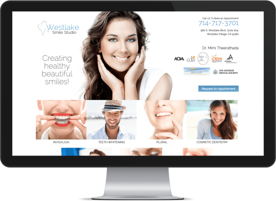 Screenshot of a prosthodontist websites on a monitor with a smiling girl