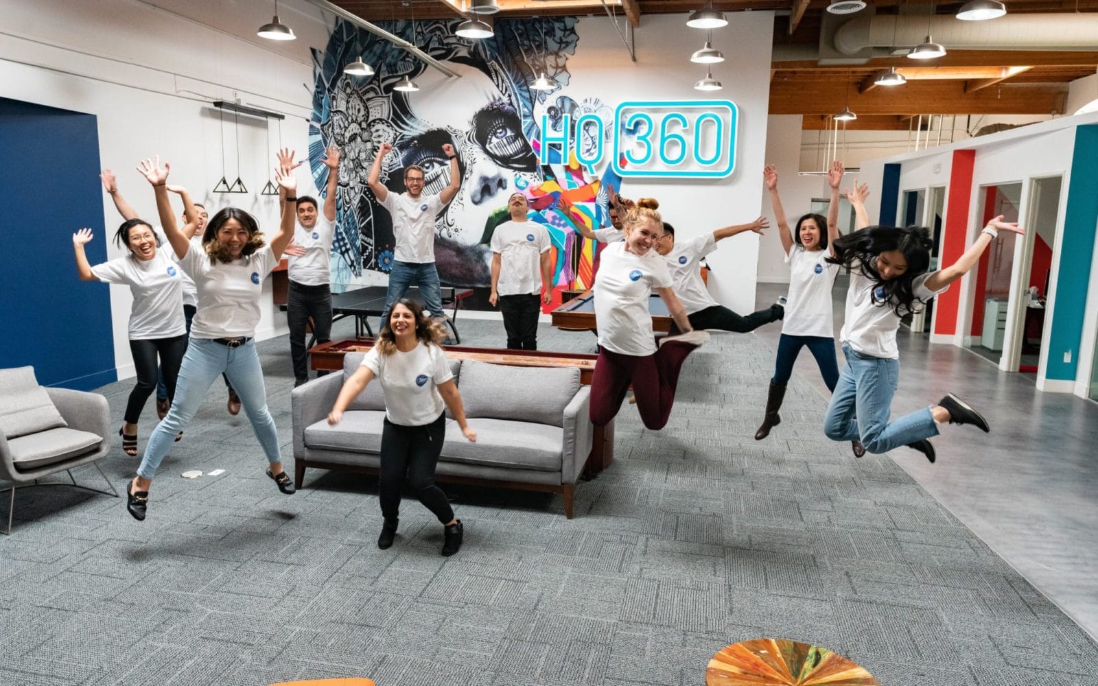 O360® team jumping up in the main room