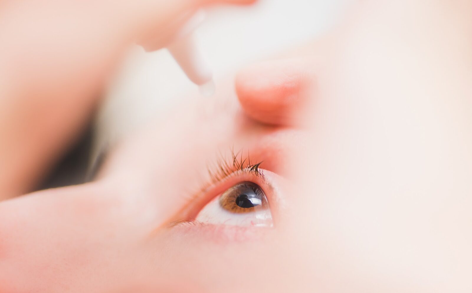 Close up of woman instilling eye drops, ophthalmology, optometry graphic