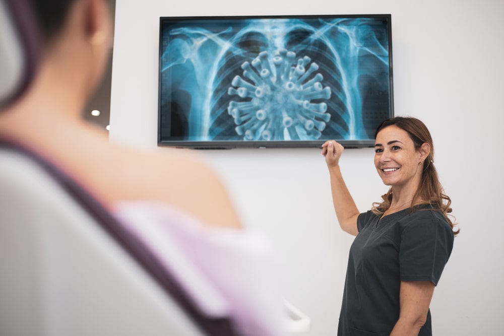 nurse pointing to television